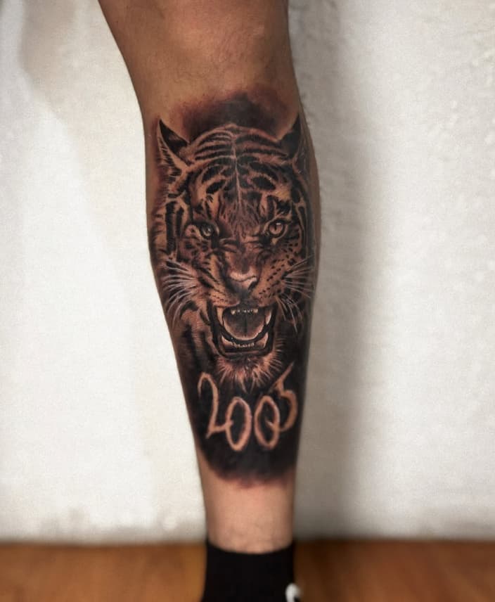 Tatuaje realista de tigre con fecha en antebrazo – Cheno Tattoo Pachuca
